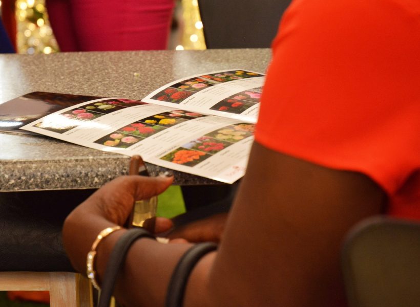 A client viewing Baraka Rose's catalogue at the IFTEX 2025 event Nairobi.