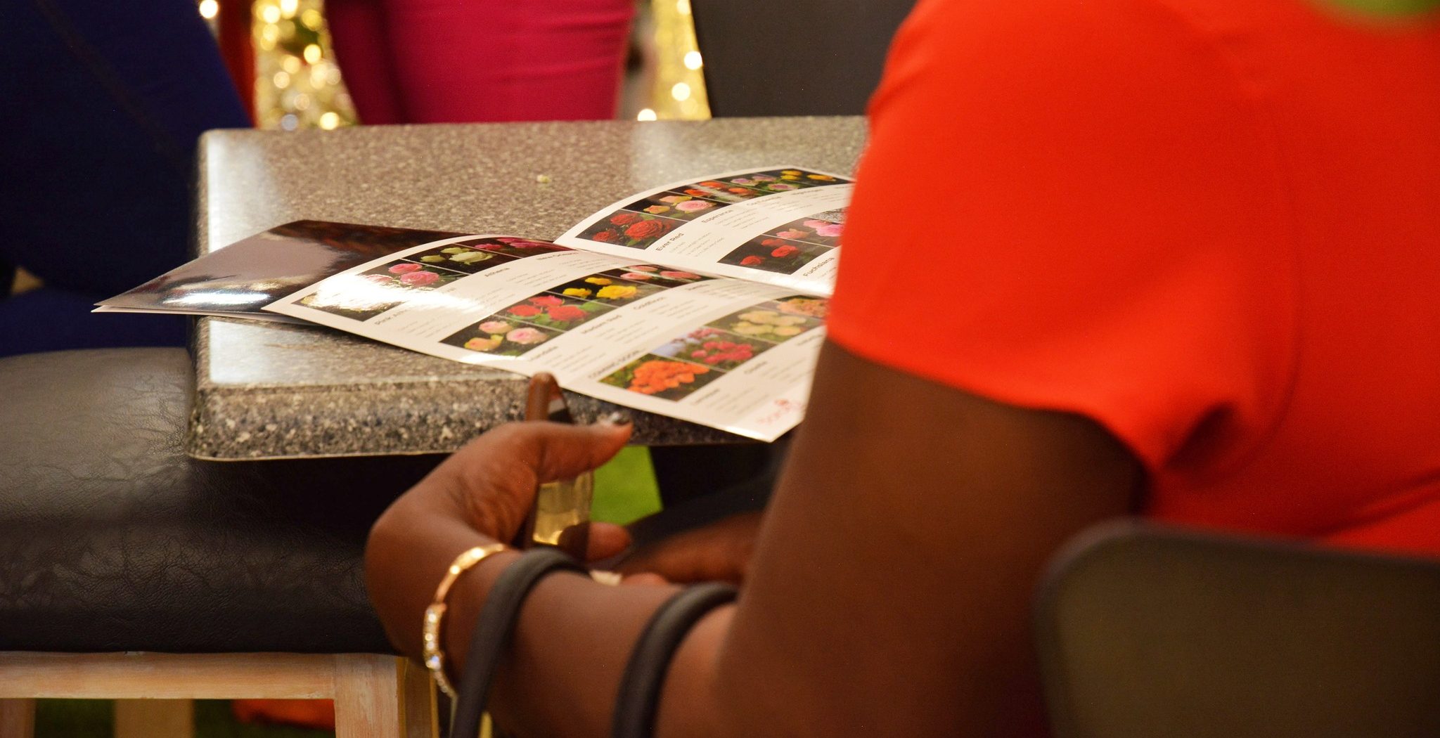 A client viewing Baraka Rose's catalogue at the IFTEX 2025 event Nairobi.